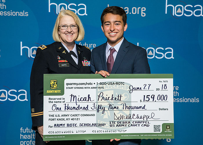 Scholarship Recipient Holding Check